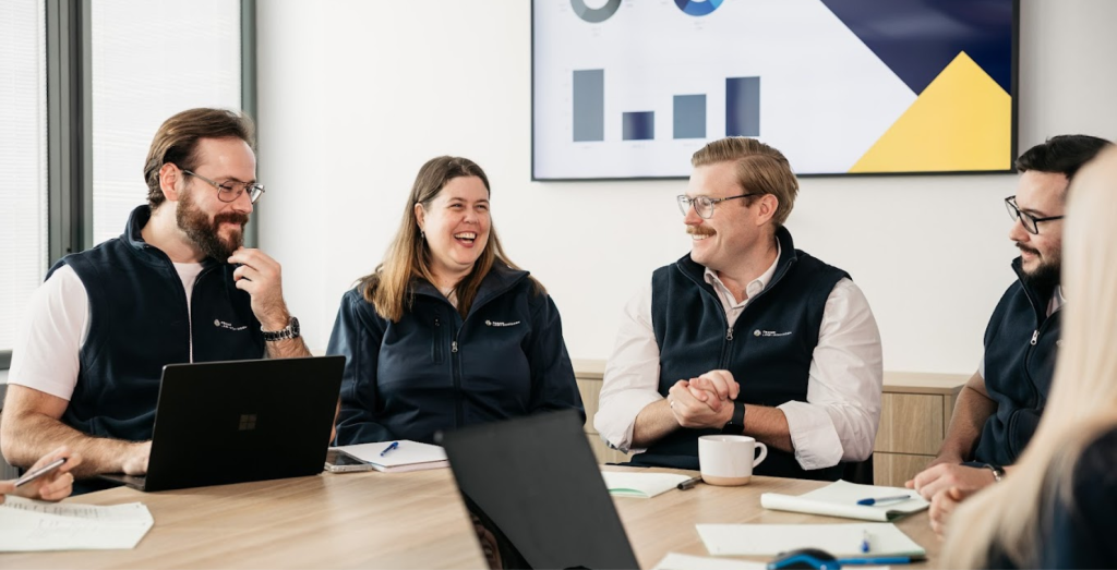 The Frank Law + Advisory team sitting at their boardroom table